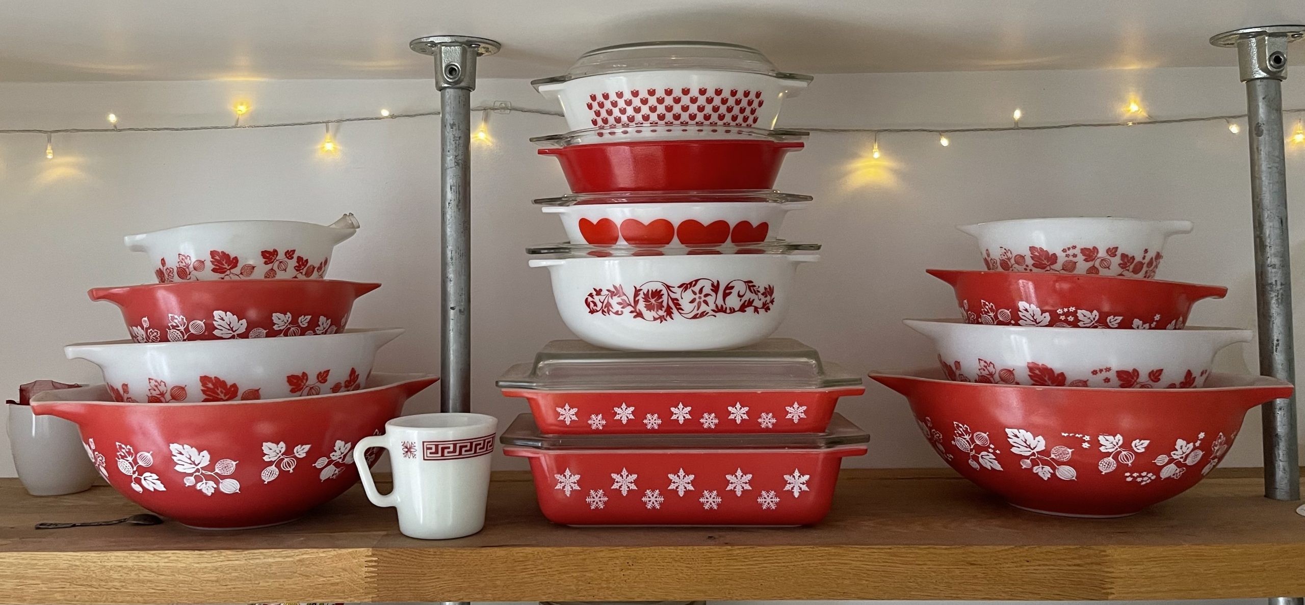 Mix and Match Pyrex sets in red and white. Patterns include Gooseberry. Greek Key, Gaiety Snowflake, Dianthus Folly and Red Hearts. Logo