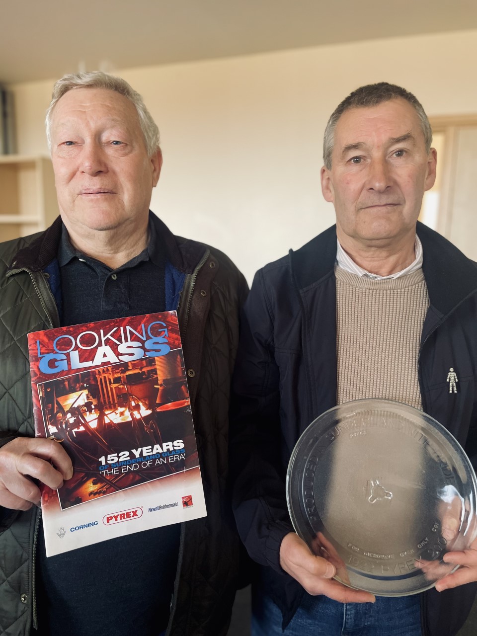 Fred and Dave holding a commemorative glass microwave plate and the final issue of ‘The Looking Glass’ Logo